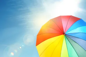 Modern color umbrella against blue sky. Sun protection