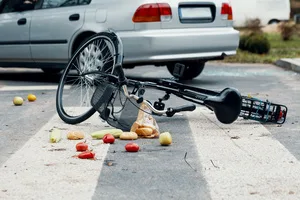 A broken bike on a pedestrian crossing after a collision with a car